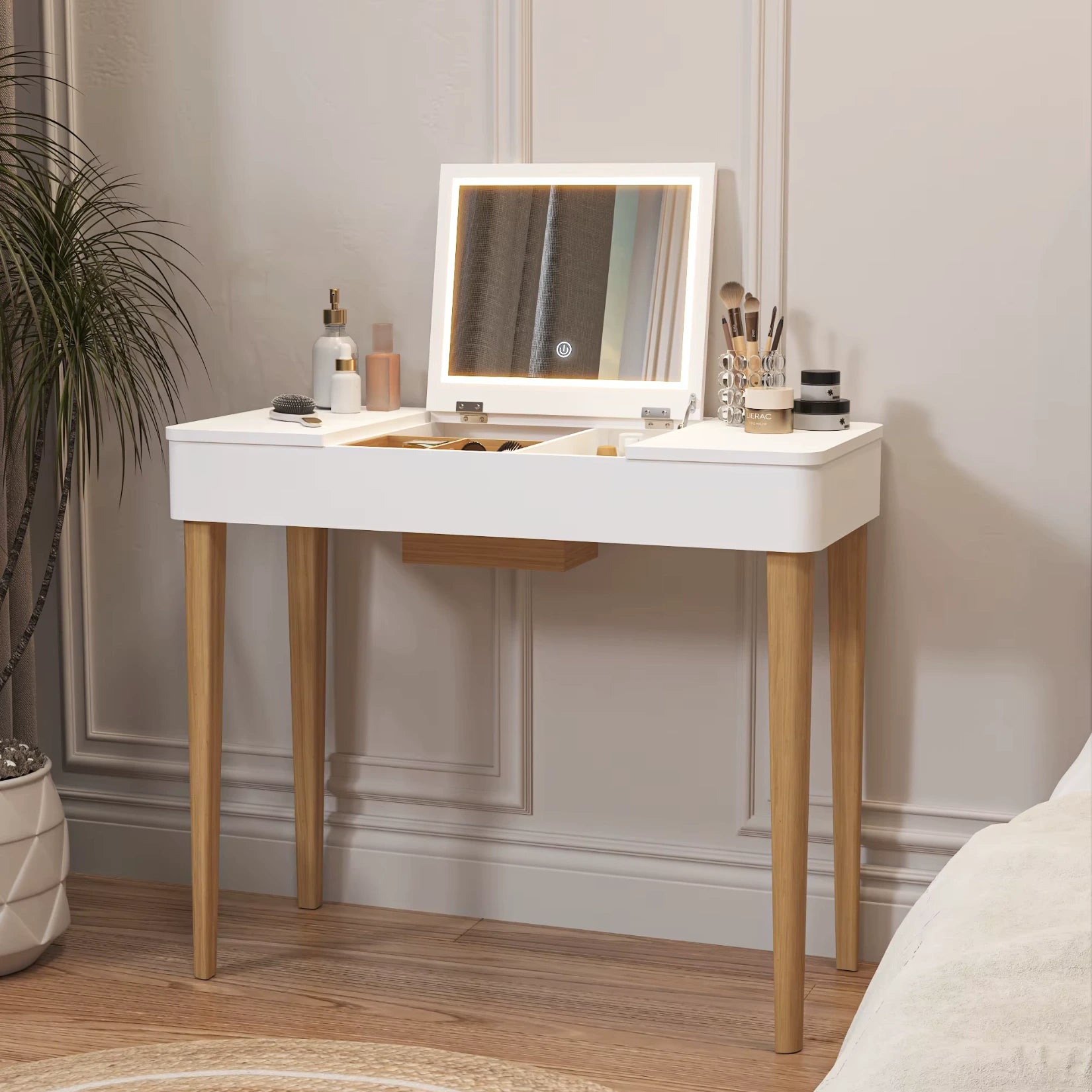 Coiffeuse avec miroir rabattable et éclairage LED dans une ambiance épurée.
