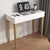Coiffeuse avec miroir rabattable transformée en bureau moderne fermé.