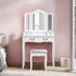 Coiffeuse grand tiroir 3 miroirs blanche installée dans une chambre mur rose.