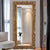 Miroir baroque de 180 cm avec cadre en bois sculpté et doré, apportant luxe et majesté à votre espace.