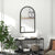 Miroir arche noir 65x110 cm installé dans un salon blanc lumineux.