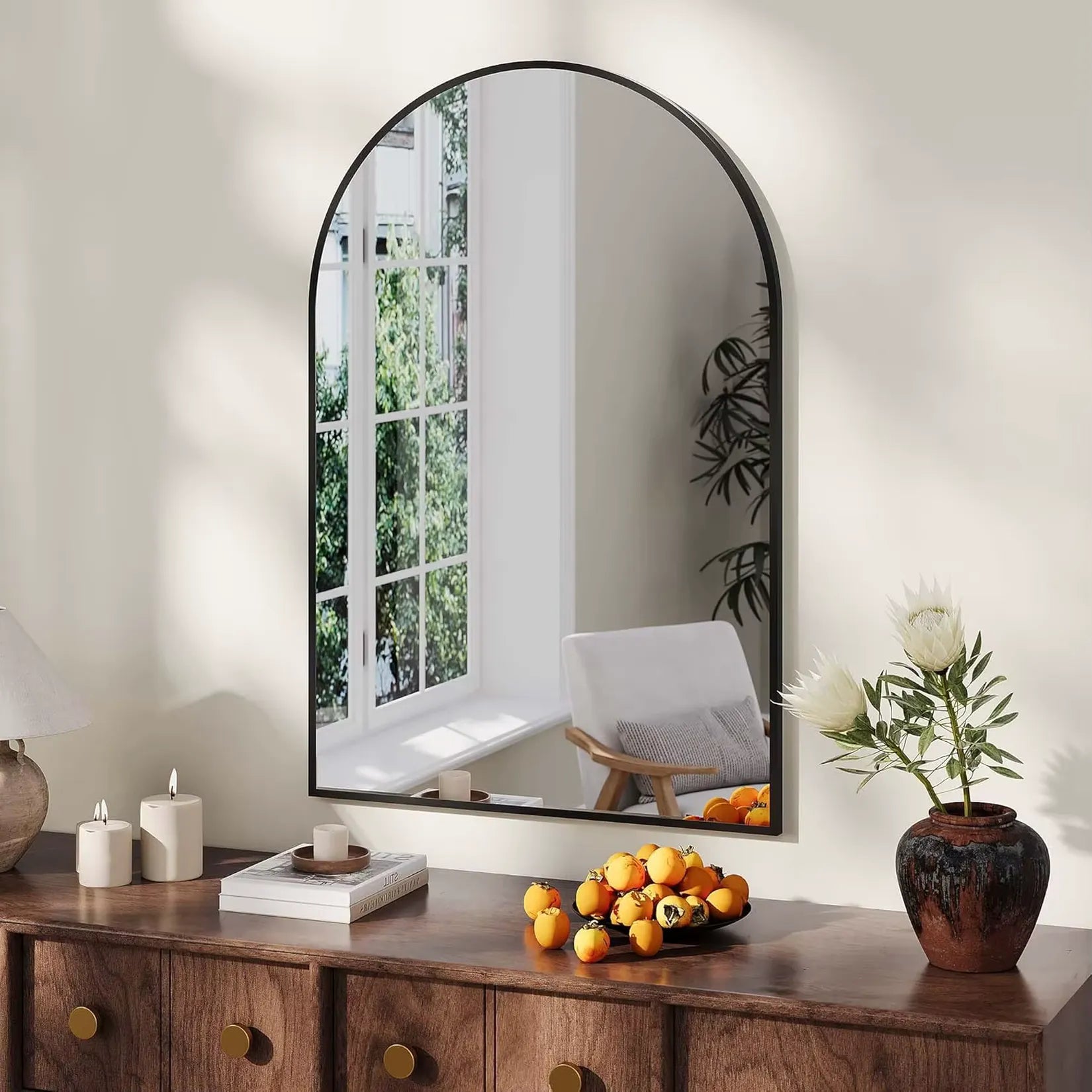 Miroir arche noir 65x95 cm au-dessus d'une console d'entrée en bois.