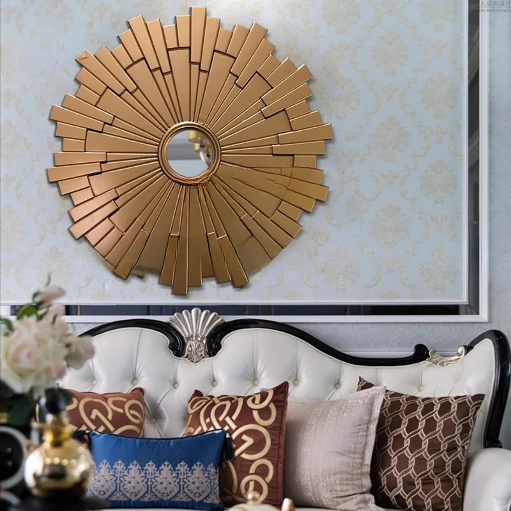 Miroir Art Déco soleil doré au-dessus d'un canapé classique.