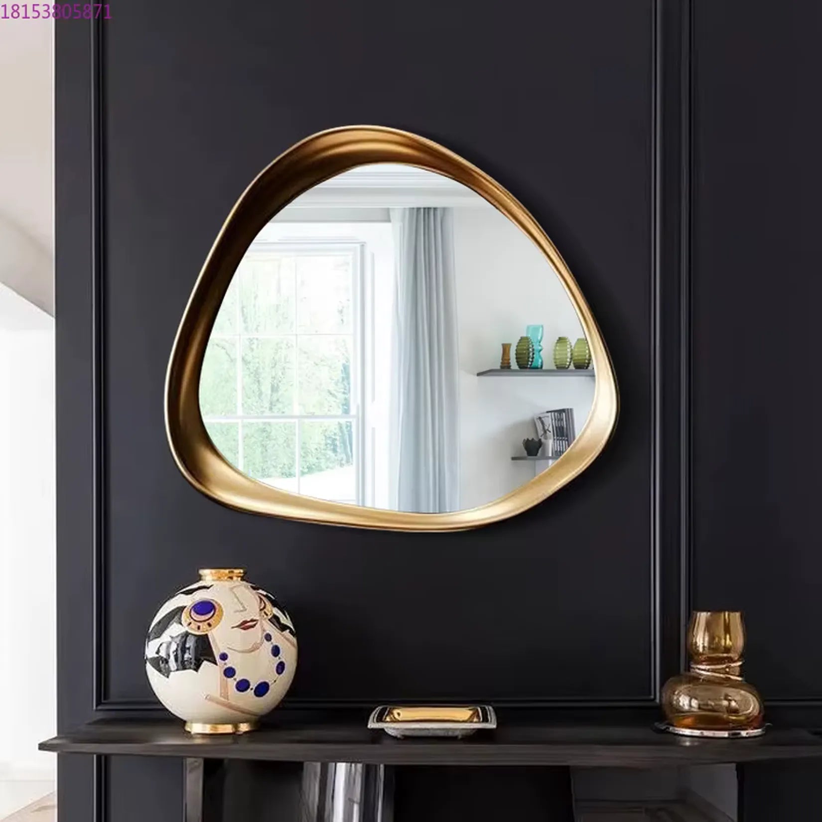Miroir Art Nouveau Doré L'Ondoyant avec cadre ondoyant sur mur noir.