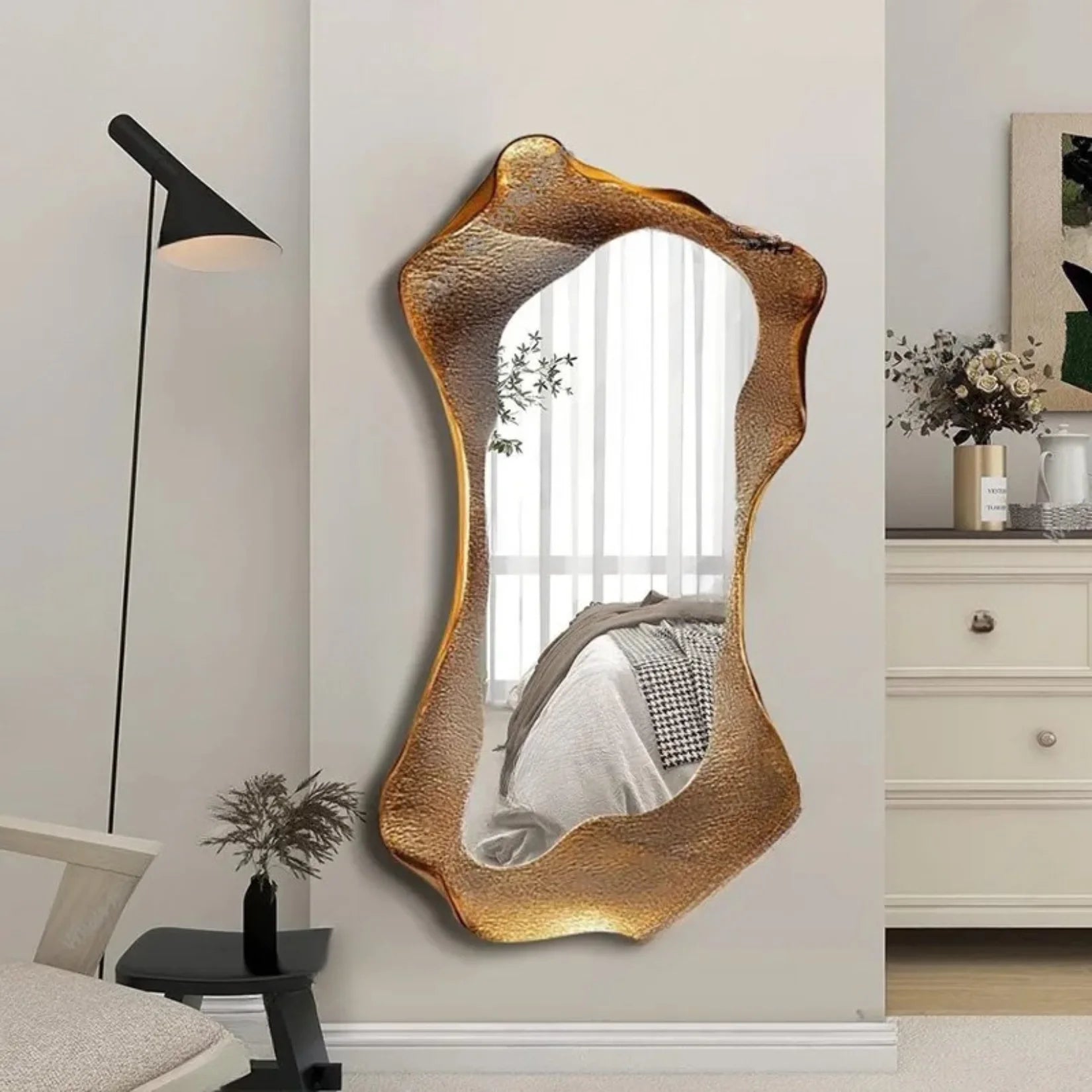 Miroir Couloir Vesuvio au cadre doré sculpté dans une chambre élégante.