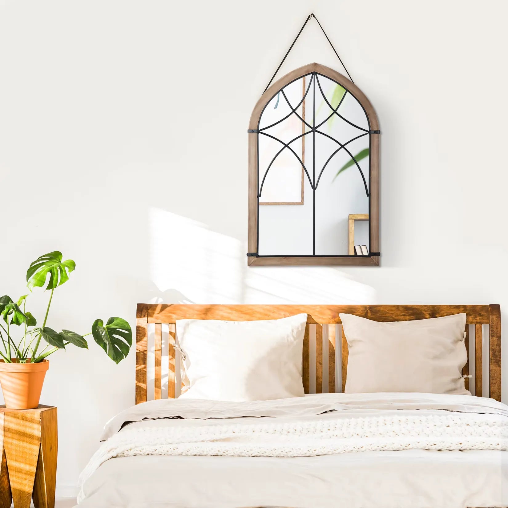 Miroir industriel bois et métal accroché au mur dans une chambre à la décoration naturelle.