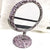 Miroir de maquillage décoré de strass roses et violets pour une ambiance chic et colorée.