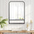Miroir métal industriel avec étagère fixé dans une chambre moderne.