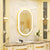 Miroir ovale LED avec cadre doré style baroque.