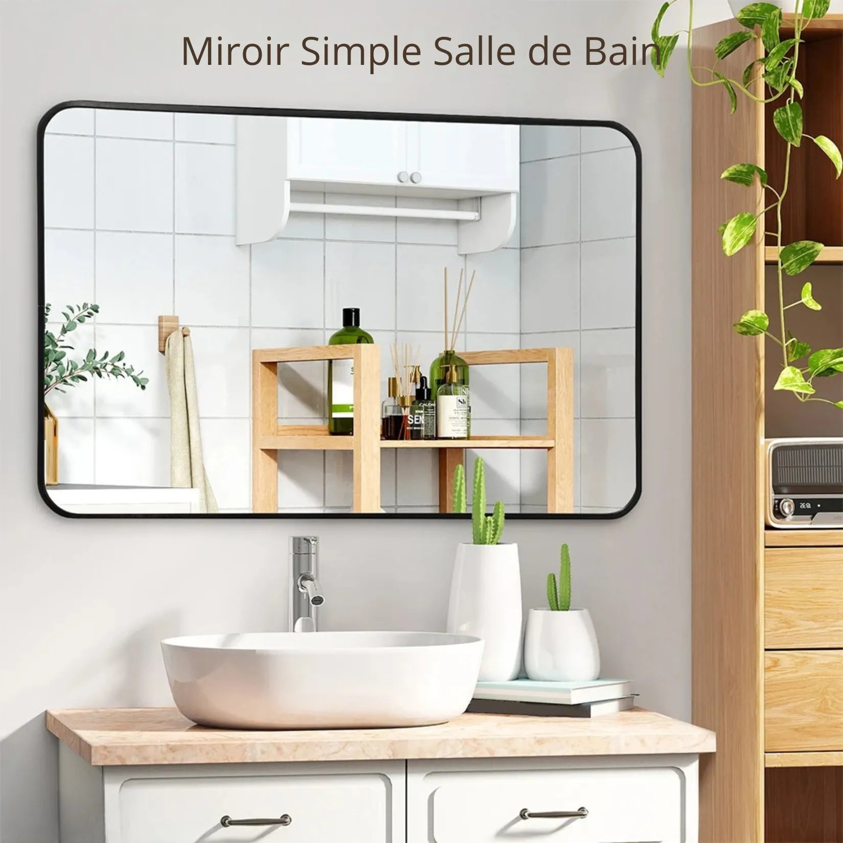 Miroir rectangulaire salle de bain noir mat monté au-dessus d'une simple vasque.