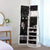 Miroir sur pied pivotant avec rangement ouvert, compartiments pour bijoux et accessoires.